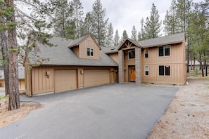 Front of house with large driveway and lots of parking