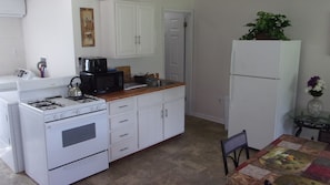 Kitchen equipped with stove, microwave, toaster, coffee-maker, pots & pans, etc.