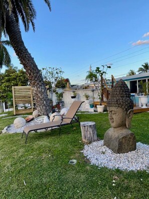 2 Giant Buddhas welcome you, hand carved from Thailand over 1000 pounds in Good Fortune & Escape to a serene's in backyard oasis on a beautiful canal, surrounded by lush Palms, and vibrant nature. Watch duck slide by, butterflies dance, Iguanas climb the 