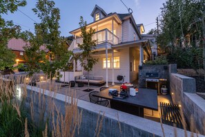 Patio w/ dining area, lounging couch, gas bbq, fire pit.