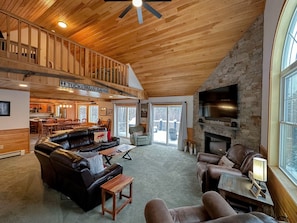 An open concept floor plan with spacious living room features a gas fireplace.