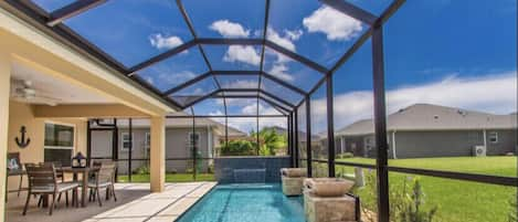 Heated Pool  in screened in lanai with three water features