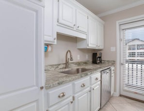 Kitchen area and balcony door.