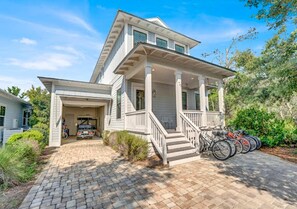 Front of house with parking for 3 vehicles.  A 6 seater golf cart and 8 full size bikes