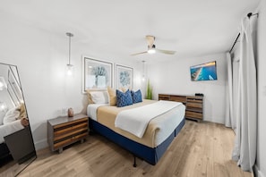 Primary Suite with a king bed, en suite bath, washer and dryer, TV, patio access and Gulf views!