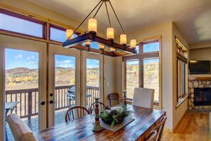 Large dining table and access to deck with BBQ grill