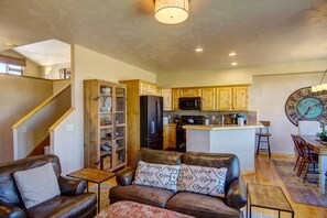 Living space with stairs up to the den area