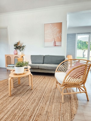 Relax on comfortable seating in the living room and enjoy the beach tones