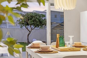 Dine at the table adjoining the kitchen and take in the lovely view of the yard.