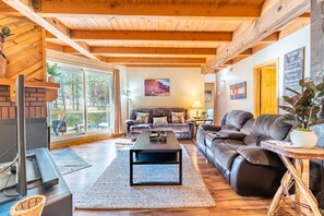 Cozy living area with flat screen TV, gas fireplace, ample seating and access to the private back deck.