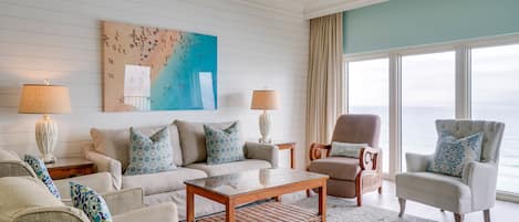 Living Room | Breathe Easy Rentals - Beautiful living room with an even more beautiful view of our Emerald green water and white sand beaches.