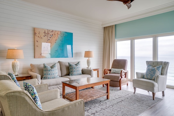 Living Room | Breathe Easy Rentals - Beautiful living room with an even more beautiful view of our Emerald green water and white sand beaches.