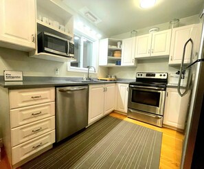 Well stocked kitchen with dishwasher, microwave, coffee maker, and more