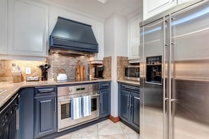 Modern appliances and ample storage in sleek kitchen design.