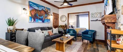 Cozy space with gas fireplace, sofa set, TV, and dining area.