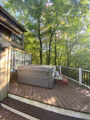 Hot tub on the deck, surrounded by beautiful trees and lake view. 