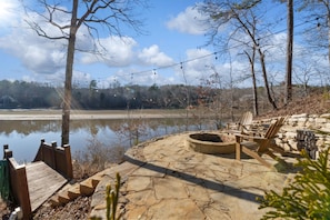 Cozy fire pit with stunning views overlooking the serene waters of Lake Wedowee. Perfect for relaxing evenings under the stars.