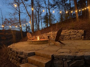  Gather around the firepit at our Lake Wedowee retreat, where glowing flames, cozy seating, and party lights set the perfect lakeside vibe. Relax under the stars, roast s’mores, and enjoy the peaceful water views.