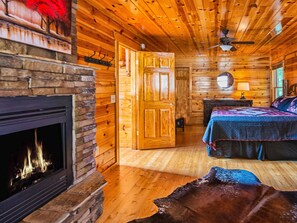 MAIN FLOOR KING BEDROOM WITH DOUBLE SIDED FIREPLACE
