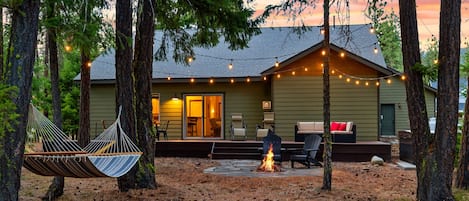 Backyard: Dining table, seating area, hot tub, wood fire pit