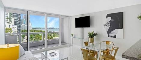 Living/dining area, Tv, balcony access, water views of Biscayne Bay and more