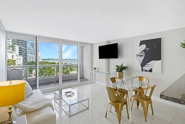 Living/dining area, Tv, balcony access, water views of Biscayne Bay and more