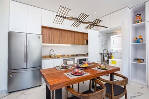 View of the dining table and kitchen.