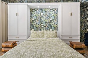 Queen size bed surrounded with spacious closet and cabinets

