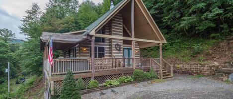 Front of cabin.  Hot tub is on the deck, just behind the flag in view