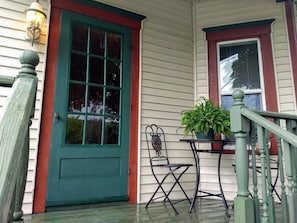 Private front porch with bistro table & chairs, overlooking Main Street.