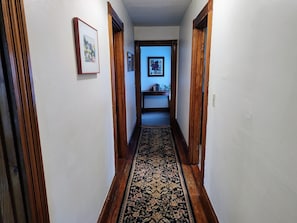 Top of stairway, hallway to bedroom, living room, kitchen and bathroom.