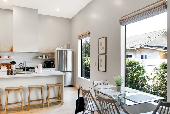 In addition to the breakfast bar seating, guests can enjoy the dining table with seating for 4