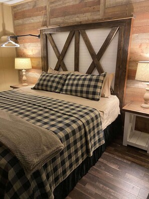 King bedroom, electric fireplace and sliding glass doors for patio access