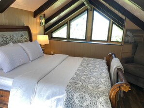 Loft bedroom, queen bed, electric fireplace and overlooks main living area 