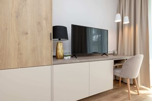 Beige, modern cabinetry and a flat-screen TV, plus a landscaped workspace.