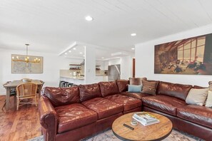 View of the spacious family room, dining area, and fully-equipped kitchen