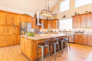 Wide-open kitchen with large counter-top. A great place to gather around.