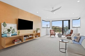 Golf course view lounge room with deck
