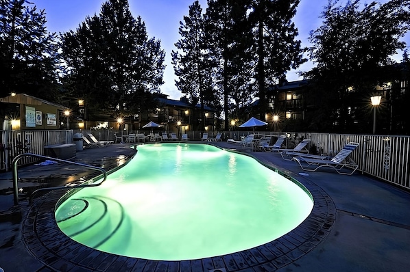 Indoor and outdoor swimming pool and poolside loungers