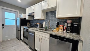Full kitchen has all the amenities you'll need with a stylish glass backsplash
