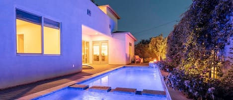 Private backyard with pool, hot tub, BBQ grill, fire pit and lounge chairs