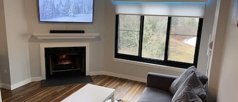 Living room with tall vaulted ceiling