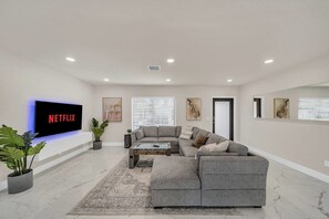 Living room with pullout sofa bed and 70 inch smart TV