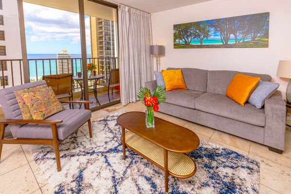 pull-out sleeper sofa, chair, coffee table in the living room with beautiful ocean views