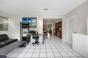 Office area with desk and seating area. 