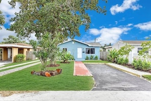 Beautiful landscaping and a driveway for parking. 