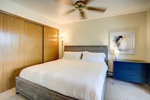 King bedroom with large closet and clothes dresser.