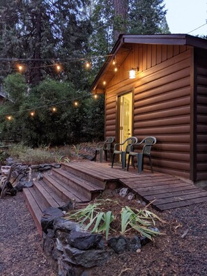 The lovely game room cabin lit up at night