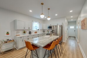 Kitchen & island bar w/ stainless appliances, bar cart & seating for 4.