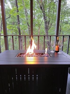 Fire table on the screened porch.